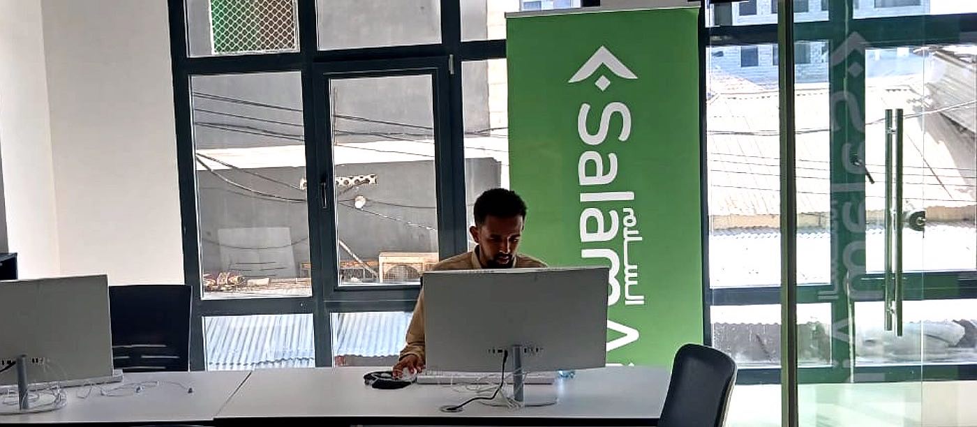 The Ibra Travel booking desk in Mogadishu, beside a SalamAir banner